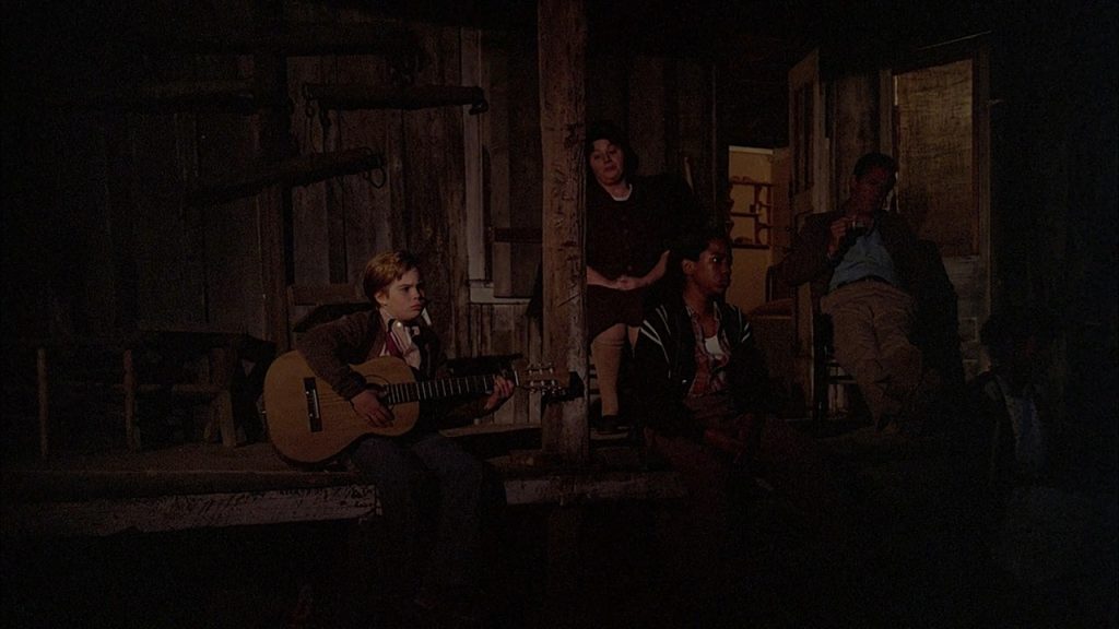 Young Elvis and his family singing in the black of night