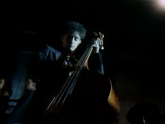 double bass player, a shot from the movie Red Heat