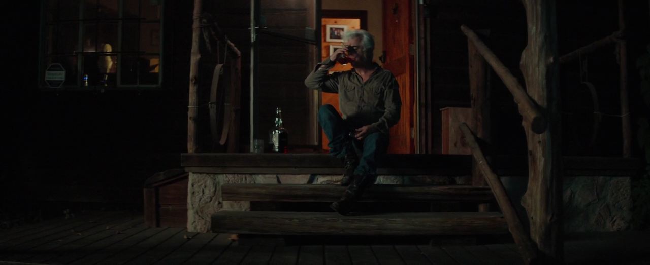 Dale Watson drinks whiskey on the porch of the house, Yellow Rose, 2020, still from the movie