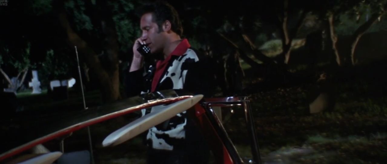 A shot from the movie The Adventures of Ford Fairlane, a phone in the 1957 Ford Fairlane 500 Skyliner