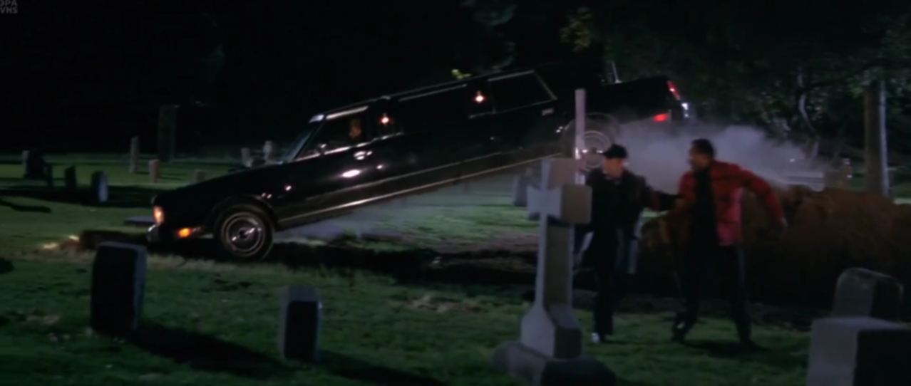 Adventures of Ford Fairlane, hearse racing through a cemetery