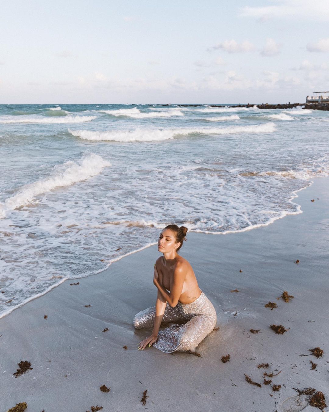 Jessica in the sea by the surf without a top