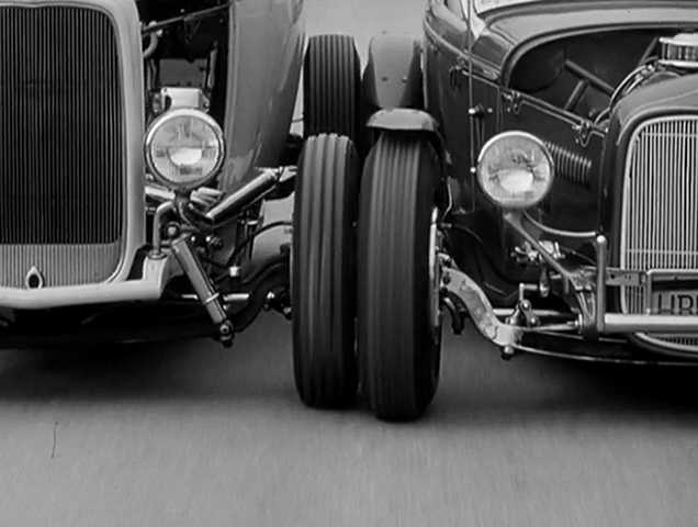 Two hot rods have a contact fight in the 1958 film Hot Rod Gang.