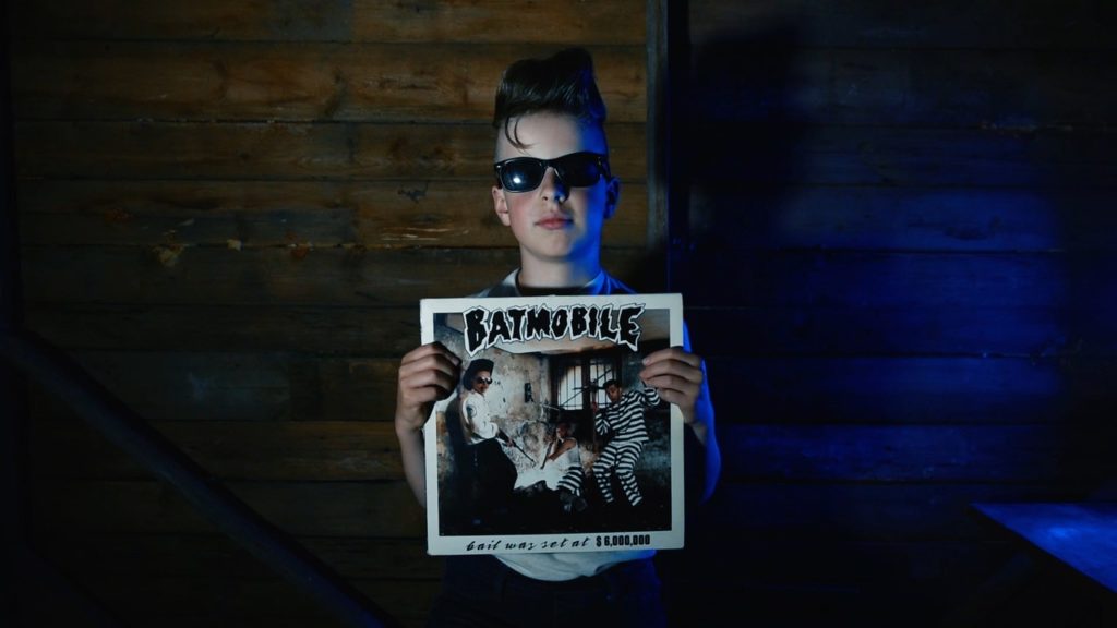 Teen holds Vinyl Batmobile
