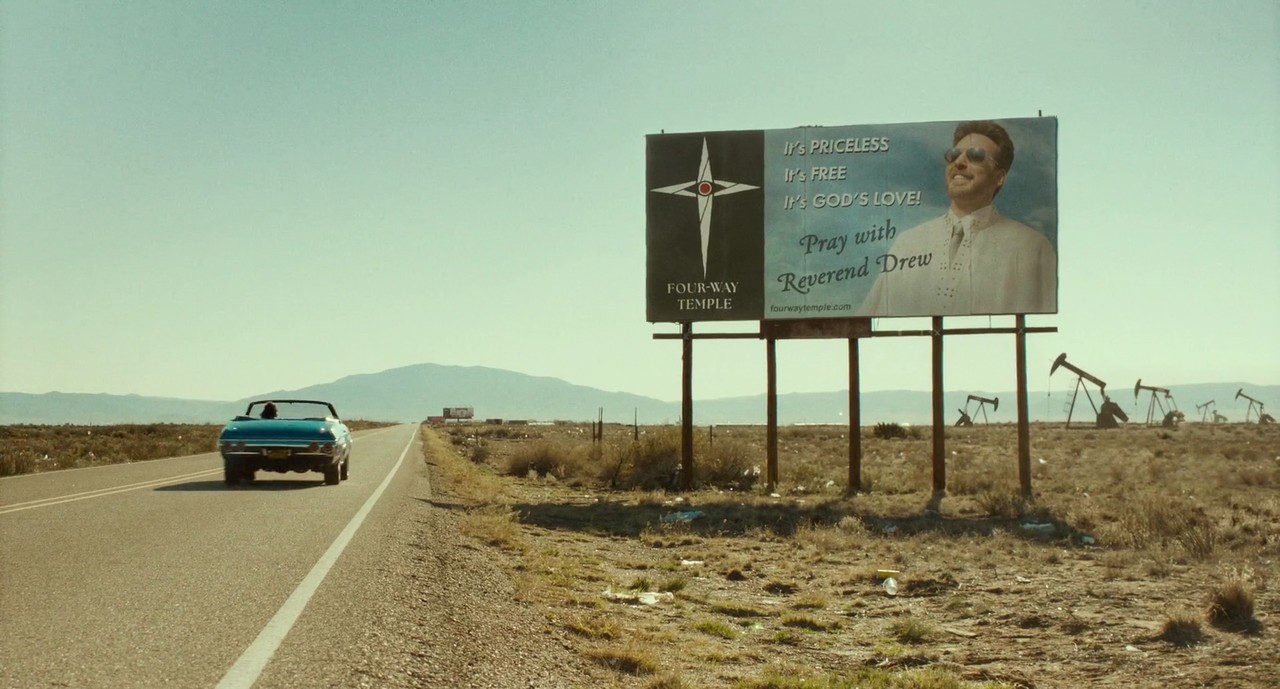 Four-way church billboard, shot from the movie Honey Don't, 2025
