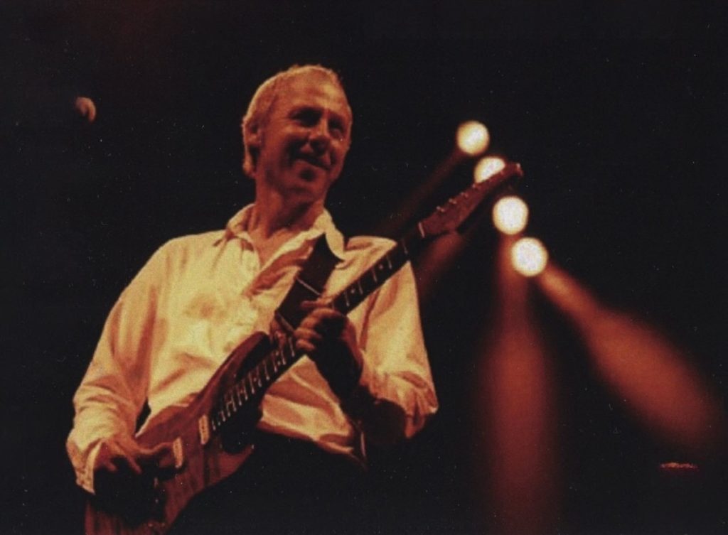 Mark Knopfler with guitar at a concert