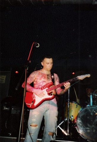 Stas Bogorad plays guitar at a concert, red Fender