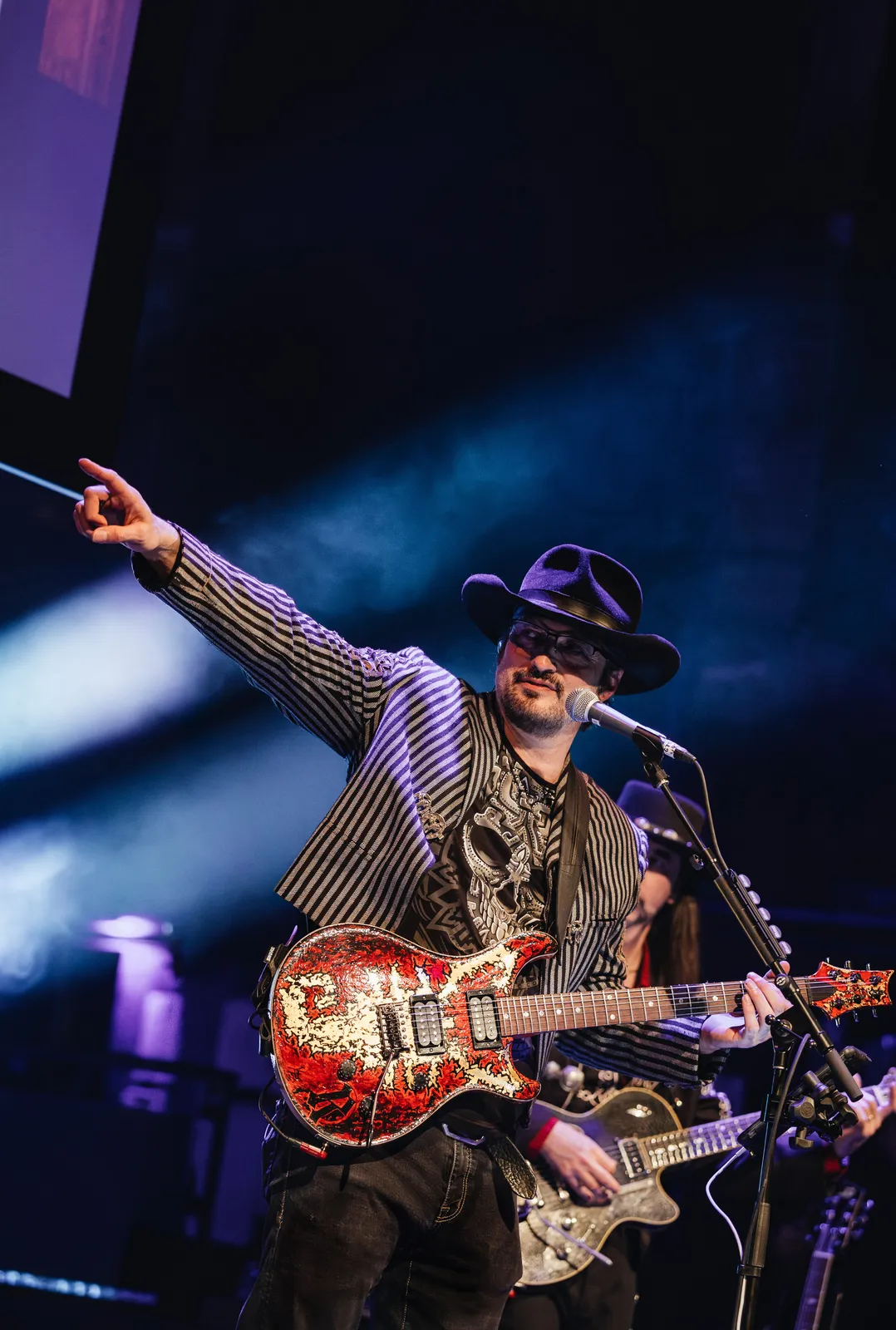 Robert Rodriguez with guitar at a concert