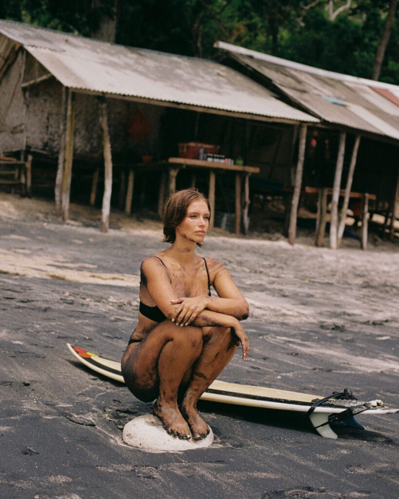 Naila May, a girl with a surfboard