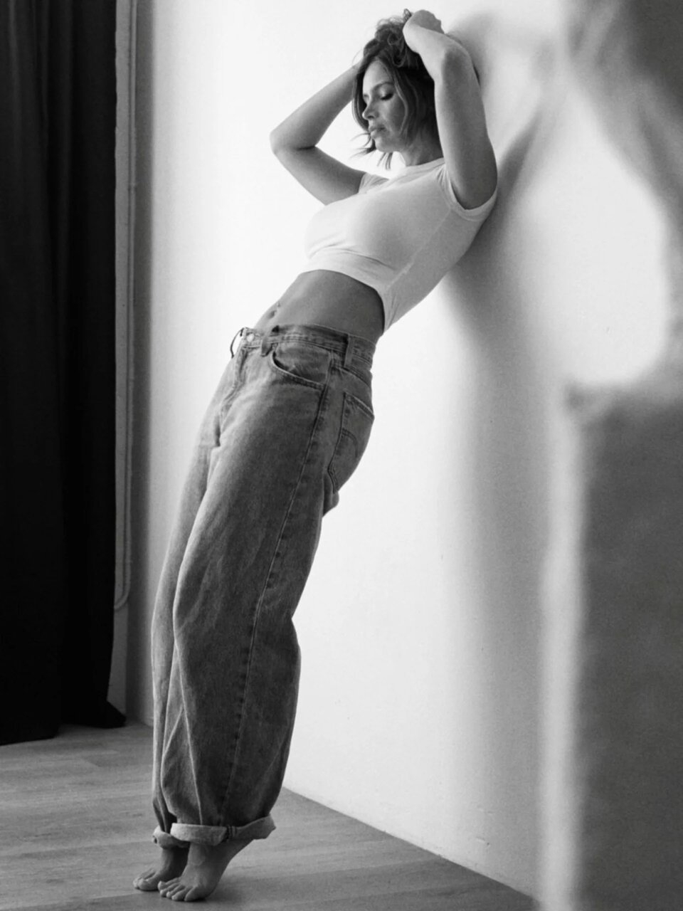 Naila van Kommer, in jeans and a tight white tank top